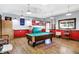 Entertaining game room with pool table, fun decor, and rustic wood flooring for a relaxed atmosphere at 186 W 600 N, Alexandria, IN 46001