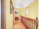 Hallway with yellow walls, wooden floors and a wooden railing at 186 W 600 N, Alexandria, IN 46001