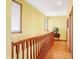 Upstairs hallway with hardwood floors, wooden railing and yellow walls at 186 W 600 N, Alexandria, IN 46001