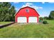 Exterior view of large red outbuilding with two garage doors and green lawn at 186 W 600 N, Alexandria, IN 46001