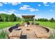 Outdoor kitchen and seating area featuring lush green lawns and landscaping at 186 W 600 N, Alexandria, IN 46001