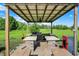 Outdoor kitchen featuring a covered area with multiple grills and appliances at 186 W 600 N, Alexandria, IN 46001