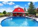 Exterior shot of above ground pool with red outbuilding and deck at 186 W 600 N, Alexandria, IN 46001