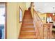 Wooden staircase leading to the second floor with natural light from a window at 186 W 600 N, Alexandria, IN 46001