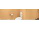 A close-up of a toilet in a bathroom with beige walls and gold fixtures at 186 W 600 N, Alexandria, IN 46001