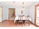 Bright dining room with hardwood floors, a classic chandelier, and seating for six at 2090 W County Road 400 S, Clayton, IN 46118