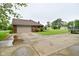 Exterior view showing a two-car garage and large concrete driveway on a cloudy day at 2090 W County Road 400 S, Clayton, IN 46118