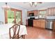 A view of the kitchen adjacent to the dining area shows black appliances and wood cabinets at 2090 W County Road 400 S, Clayton, IN 46118