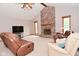 Cozy living room featuring a brick fireplace, plush seating, and natural light at 2090 W County Road 400 S, Clayton, IN 46118