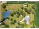 Bird's-eye view of home with a pond, pool, lush landscaping, and bordering farm fields at 3000 E County Road 400 N, Muncie, IN 47303
