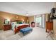 Warm bedroom featuring a comfortable bed, upholstered bench, and natural lighting at 3000 E County Road 400 N, Muncie, IN 47303