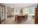 Sunlit dining room with wood table and chairs, chandelier, and views of the backyard at 3000 E County Road 400 N, Muncie, IN 47303