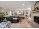 Open-concept living area with fireplace, brick hearth, and views into the kitchen at 3000 E County Road 400 N, Muncie, IN 47303