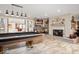 Spacious living area featuring a pool table, fireplace, and built in shelving, perfect for entertaining at 3000 E County Road 400 N, Muncie, IN 47303