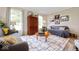 Bright living room with couches, rug, wood floors, and natural light at 3000 E County Road 400 N, Muncie, IN 47303