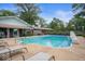 Beautiful pool area with lounge chairs, mature trees, and lush landscaping at 3000 E County Road 400 N, Muncie, IN 47303