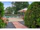 Tranquil pool area with an outdoor dining setup, surrounded by lush greenery and floral accents at 3000 E County Road 400 N, Muncie, IN 47303