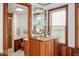 Charming wet bar featuring glass shelving, wood cabinetry, and close proximity to a shower at 3000 E County Road 400 N, Muncie, IN 47303