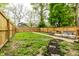Spacious backyard featuring a wooden fence, lush greenery, and a cozy deck area at 3047 N New Jersey St, Indianapolis, IN 46205