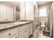 Well-lit bathroom with a granite countertop vanity, neutral walls, and tile flooring at 3047 N New Jersey St, Indianapolis, IN 46205