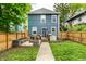 Beautiful two-story home with a well-manicured lawn, wooden fence, and charming outdoor deck area at 3047 N New Jersey St, Indianapolis, IN 46205