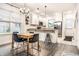Eat-in kitchen with modern finishes, white cabinets, stainless steel appliances, and stylish lighting at 3047 N New Jersey St, Indianapolis, IN 46205