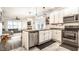 Open-concept kitchen with stainless steel appliances, white cabinets, and seamless flow into living area at 3047 N New Jersey St, Indianapolis, IN 46205