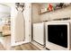 Modern laundry room featuring updated appliances, storage shelves, and convenient ironing space at 3047 N New Jersey St, Indianapolis, IN 46205