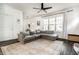 Comfortable living room with a large gray sectional sofa, bright windows, and stylish rug at 3047 N New Jersey St, Indianapolis, IN 46205