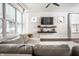 Bright living room featuring a modern sofa, TV, shelves, and natural light at 3047 N New Jersey St, Indianapolis, IN 46205