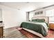 Bright main bedroom featuring hardwood floors, a king bed, and natural light at 3047 N New Jersey St, Indianapolis, IN 46205