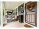 Inviting front porch with comfortable seating, decorative rug, and stylish lighting at 3047 N New Jersey St, Indianapolis, IN 46205