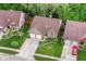 Aerial view of a well-maintained home with a landscaped yard, mature trees, and a two-car garage at 3348 Fox Orchard Cir, Indianapolis, IN 46214