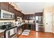 Modern kitchen featuring stainless steel appliances, rich wood cabinets, and durable countertops at 3348 Fox Orchard Cir, Indianapolis, IN 46214