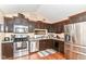 Well-equipped kitchen with dark cabinets, stainless steel appliances, and a view of the backyard at 3348 Fox Orchard Cir, Indianapolis, IN 46214
