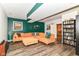 Well lit living room with hardwood floors, a comfortable sectional, and a bookshelf in the finished basement at 3348 Fox Orchard Cir, Indianapolis, IN 46214