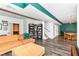 Spacious finished basement living room with a comfortable sectional couch, a bookshelf, and access to the dining room and stairs at 3348 Fox Orchard Cir, Indianapolis, IN 46214