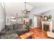 Cozy living room with high ceilings, wood floors, a fireplace, and a comfortable gray sectional at 3348 Fox Orchard Cir, Indianapolis, IN 46214