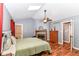 This primary bedroom features a fireplace, vaulted ceilings, and wood floors at 3348 Fox Orchard Cir, Indianapolis, IN 46214