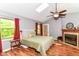 This primary bedroom features a fireplace, vaulted ceilings, a skylight and wood floors at 3348 Fox Orchard Cir, Indianapolis, IN 46214