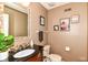 This powder room has a granite sink, neutral walls, and artwork at 3348 Fox Orchard Cir, Indianapolis, IN 46214