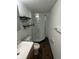 Small bathroom featuring a shower, toilet, sink, and shelves at 3541 Alpine Pl, Indianapolis, IN 46226