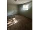 A carpeted bedroom with natural light streaming through the window at 3541 Alpine Pl, Indianapolis, IN 46226