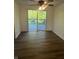 Well lit dining room featuring vinyl wood flooring and a sliding glass door leading to a patio deck at 3541 Alpine Pl, Indianapolis, IN 46226
