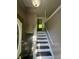 Bright entryway with newly painted walls and trim, leading to upper level and a clear view of the front door at 3541 Alpine Pl, Indianapolis, IN 46226