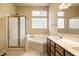 Well-lit bathroom with glass shower, soaking tub, double vanity, and natural light from unique glass block window at 3556 Towne Dr, Carmel, IN 46032