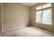 Bright bedroom with neutral carpeting and large window, perfect for relaxation and personalization at 3556 Towne Dr, Carmel, IN 46032