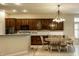Open-concept dining and kitchen area with wooden cabinets and chandelier lighting at 3556 Towne Dr, Carmel, IN 46032