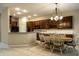 Well-lit dining area and kitchen featuring dark wood cabinetry and modern appliances at 3556 Towne Dr, Carmel, IN 46032