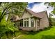 Charming brick home with a sunroom and well-manicured lawn at 3556 Towne Dr, Carmel, IN 46032